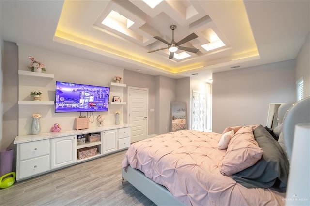 816 Samaria St, Weslaco, TX 78596 - bedroom with a tray ceiling, light wood-style flooring, and ceiling fan
