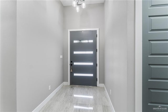 doorway featuring an inviting chandelier