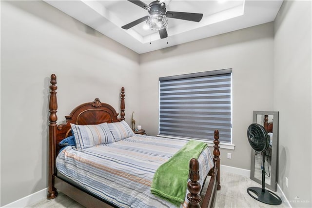 bedroom featuring a tray ceiling and ceiling fan