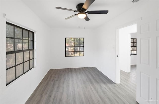 empty room featuring light wood-type flooring and ceiling fan