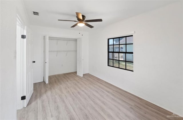 empty room featuring ceiling fan and light wood-type flooring