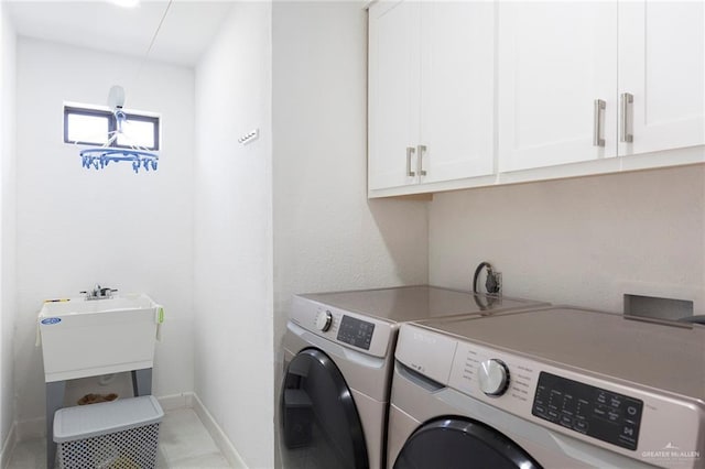 washroom featuring cabinets and washer and dryer