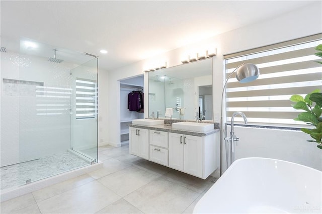 bathroom with vanity and independent shower and bath