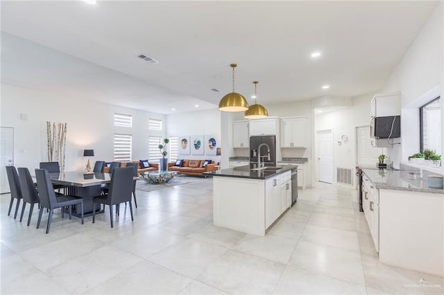 kitchen with white cabinetry, dishwasher, sink, hanging light fixtures, and a kitchen island with sink