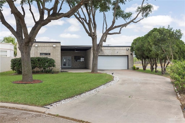 view of front facade featuring a front lawn, a garage, and a carport