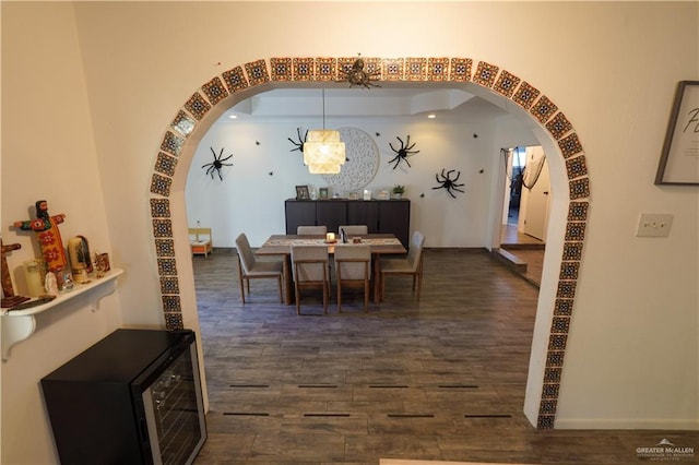 dining room featuring dark hardwood / wood-style flooring and an inviting chandelier