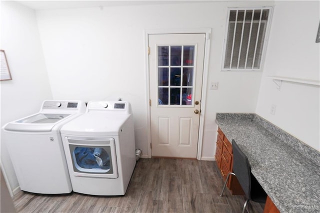 laundry area featuring washer and clothes dryer and dark wood-type flooring