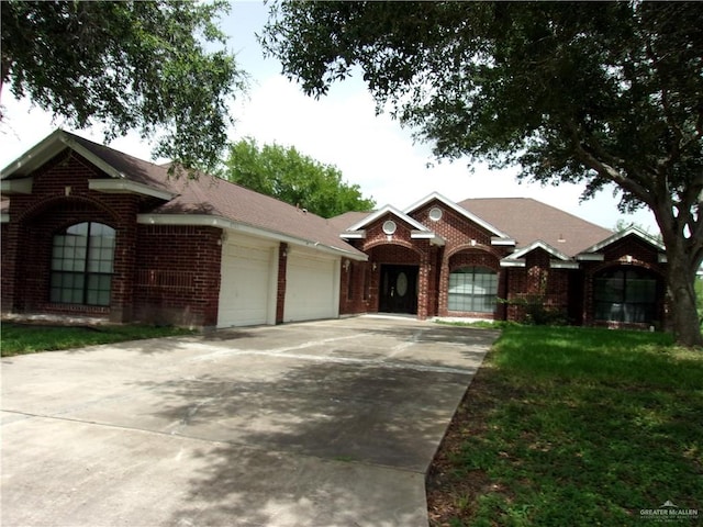 ranch-style house with a garage and a front lawn