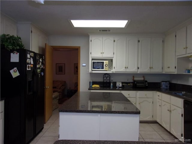 kitchen featuring white cabinets, a center island, light tile patterned flooring, and black appliances