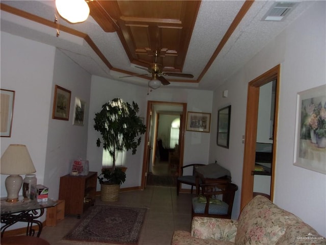 tiled living room featuring ceiling fan and a textured ceiling