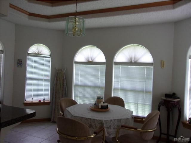 tiled dining room featuring a chandelier