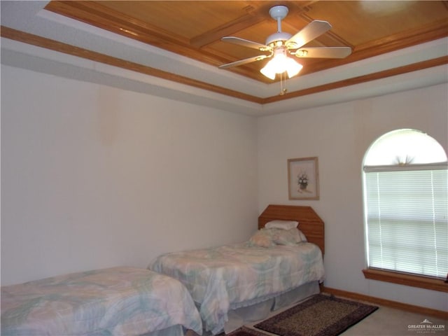 carpeted bedroom featuring ceiling fan, a raised ceiling, wood ceiling, and crown molding