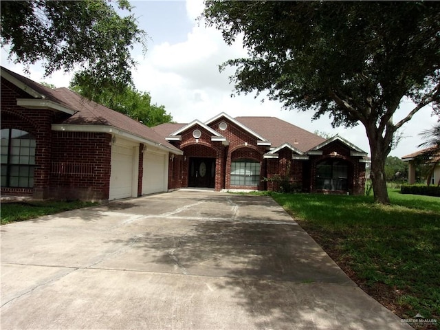 single story home with a front yard and a garage