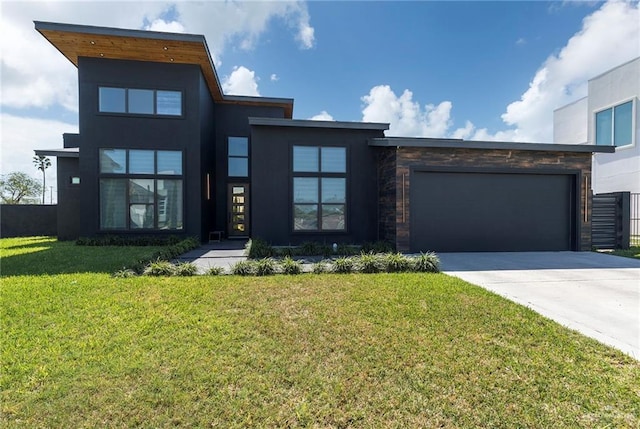 modern home with driveway, stucco siding, a front lawn, a garage, and stone siding