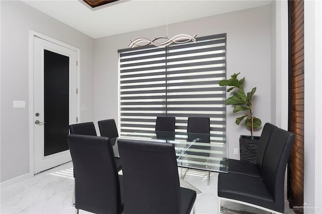 dining room with baseboards and marble finish floor