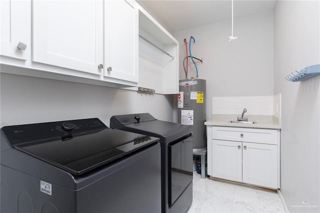 clothes washing area with washing machine and clothes dryer, cabinet space, water heater, a sink, and marble finish floor