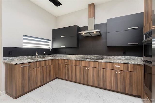 kitchen with wall chimney exhaust hood, modern cabinets, marble finish floor, and a sink