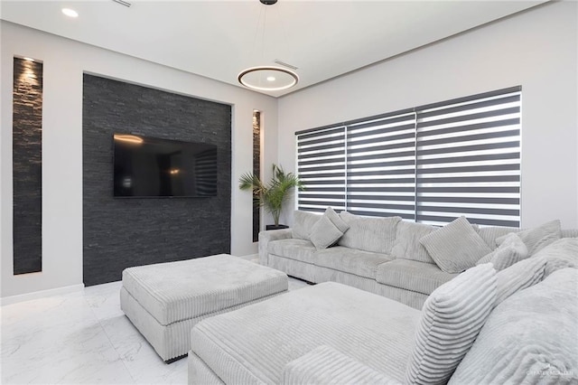 living room featuring recessed lighting and marble finish floor