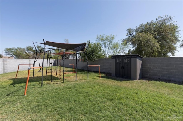 view of yard with a storage shed, a playground, and a fenced backyard