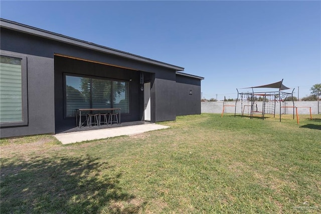 view of yard with a patio, a playground, and fence