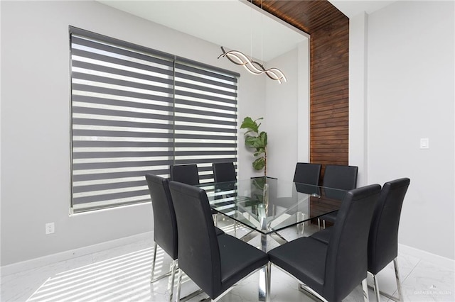 dining area with marble finish floor and baseboards