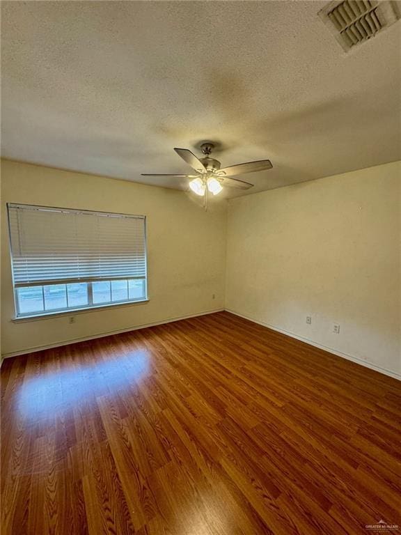 2100 Emory Ave, Mcallen, TX 78504 - unfurnished room with ceiling fan, visible vents, baseboards, a textured ceiling, and wood finished floors