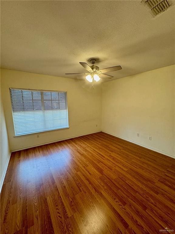 2100 Emory Ave, Mcallen, TX 78504 - spare room featuring ceiling fan, visible vents, baseboards, a textured ceiling, and wood finished floors