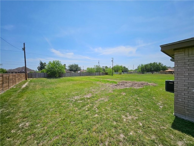 view of yard featuring fence and cooling unit