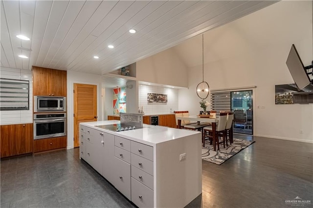 2411 Holland Ave, Edinburg, TX 78539 - kitchen featuring stainless steel appliances, a center island, brown cabinets, recessed lighting, and light countertops
