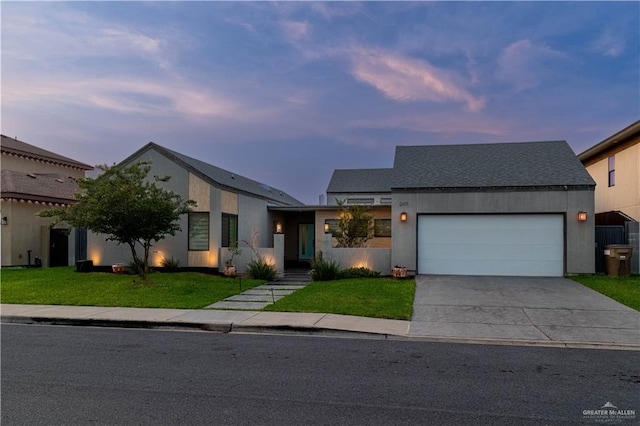 2411 Holland Ave, Edinburg, TX 78539 - view of front facade with a yard, a garage, and driveway