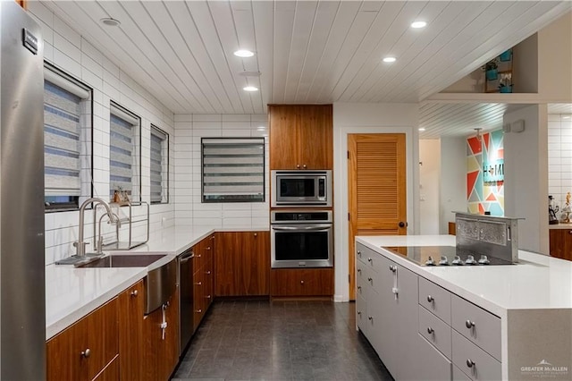 2411 Holland Ave, Edinburg, TX 78539 - kitchen with appliances with stainless steel finishes, recessed lighting, brown cabinets, light countertops, and wood ceiling