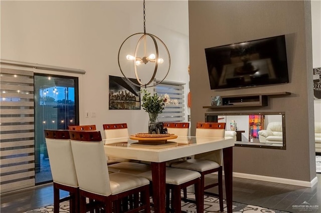 2411 Holland Ave, Edinburg, TX 78539 - dining area featuring a chandelier, baseboards, and a towering ceiling