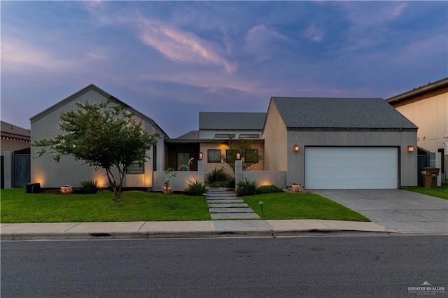 2411 Holland Ave, Edinburg, TX 78539 - view of front of house with driveway, a garage, and a lawn