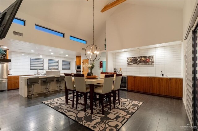2411 Holland Ave, Edinburg, TX 78539 - dining area with dark wood-type flooring, high vaulted ceiling, a chandelier, beamed ceiling, and beverage cooler