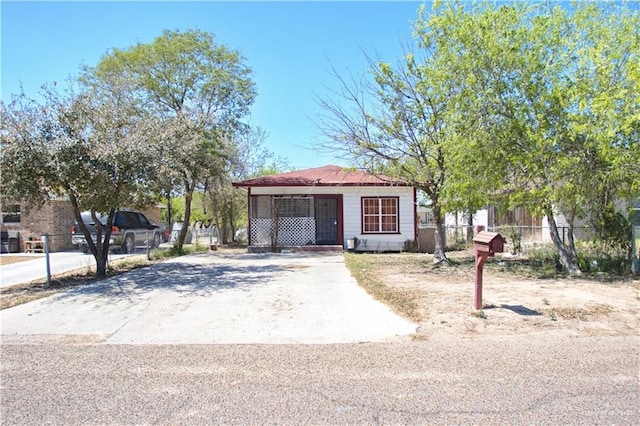 view of front of house featuring driveway and fence