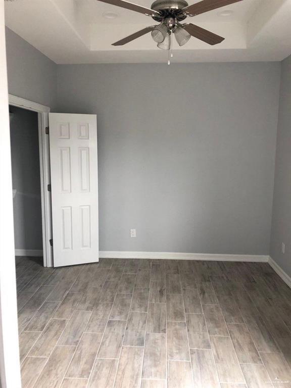 2705 Primrose Ave, Edinburg, TX 78541 - empty room with a raised ceiling and ceiling fan