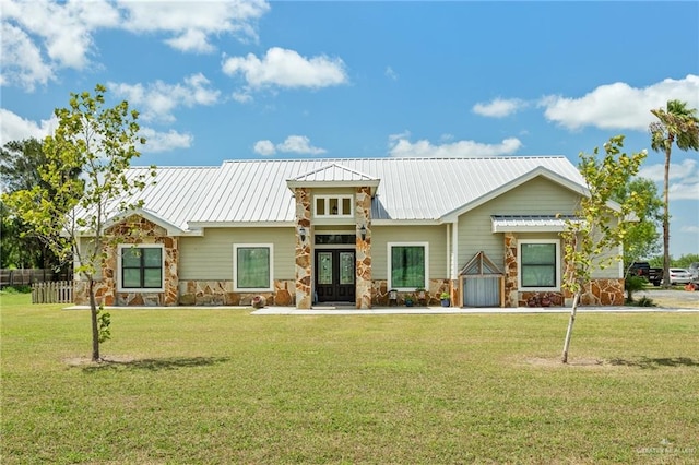 view of front facade featuring french doors and a front lawn