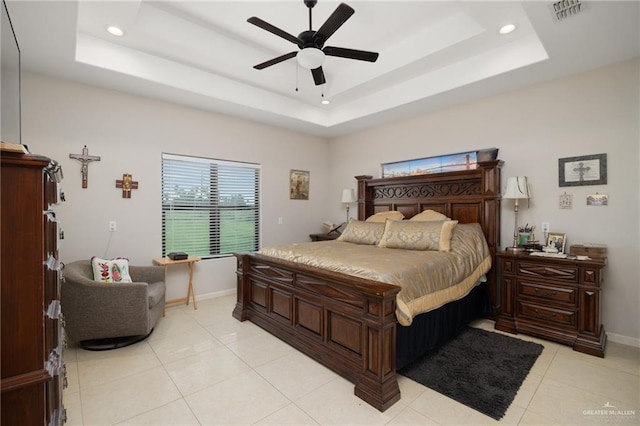 bedroom featuring a tray ceiling, ceiling fan, and light tile patterned flooring