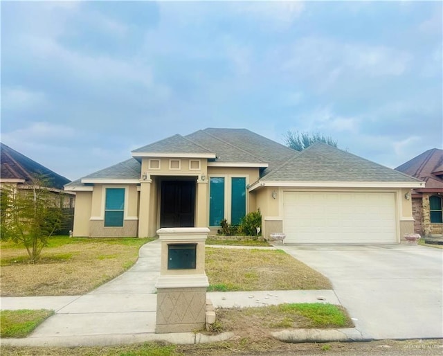 view of front of house featuring a garage and a front yard