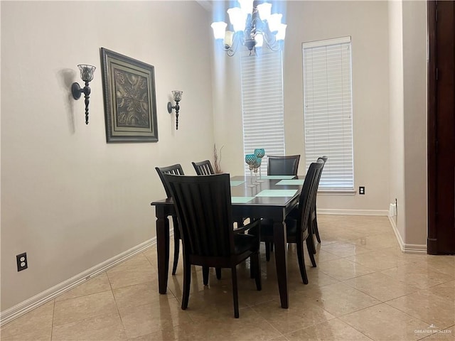 dining room with light tile patterned floors and a notable chandelier