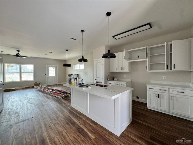 kitchen with open floor plan, baseboards, white cabinetry, and dark wood-style flooring