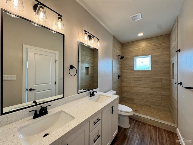 1600 Monterrey Cir, Brownsville, TX 78526 - full bath with a tile shower, double vanity, wood finished floors, and recessed lighting