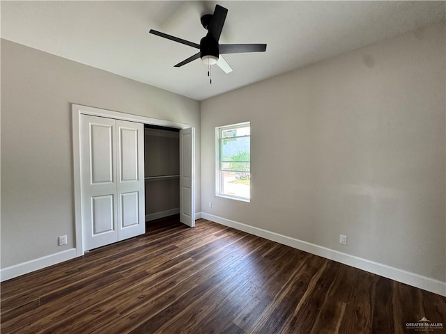 unfurnished bedroom featuring ceiling fan, baseboards, dark wood-style flooring, and a closet