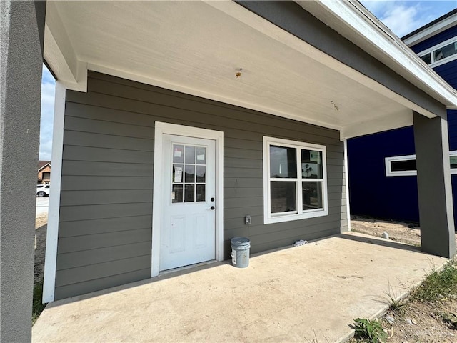 property entrance with a patio area
