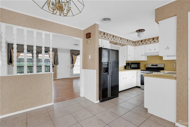 5618 Jack Nicklaus Dr, Palm Valley, TX 78552 - kitchen with light tile patterned floors, black appliances, a sink, and visible vents