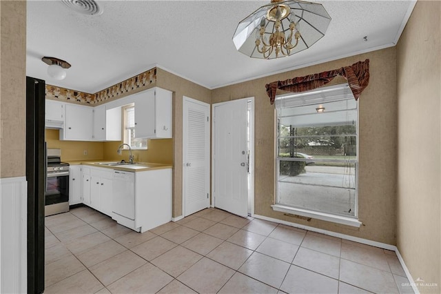 5618 Jack Nicklaus Dr, Palm Valley, TX 78552 - kitchen featuring stainless steel electric range oven, light countertops, white cabinets, a textured ceiling, and dishwasher