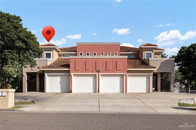 3011 S L Ln Unit B, Mcallen, TX 78503 - view of front of house featuring a tiled roof, stucco siding, driveway, and a garage
