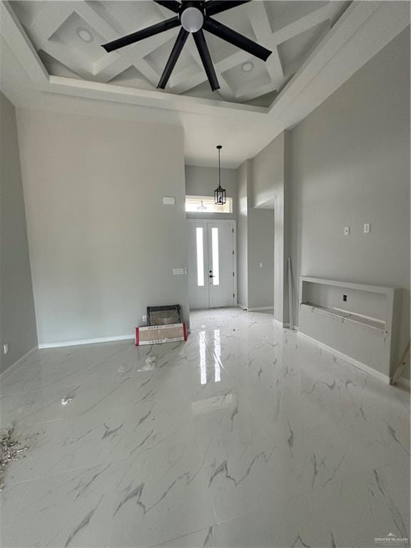 entrance foyer featuring ceiling fan with notable chandelier, beam ceiling, and a high ceiling