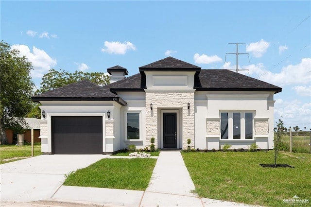 prairie-style house featuring a garage and a front lawn