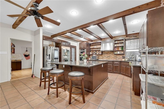1205 Susan Dr, Edinburg, TX 78539 - kitchen with open shelves, a ceiling fan, light tile patterned floors, stainless steel fridge, and a breakfast bar area